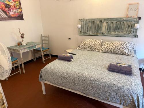 a bedroom with a bed and a table with a table at Cà Bartolomeo in Finale Ligure