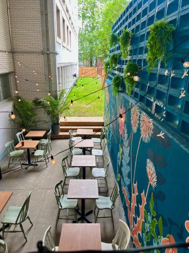a restaurant with tables and chairs and a mural on the wall at La Sainte Paix in Quebec City