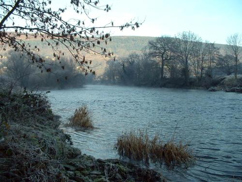 a body of water with grass in the middle at The Hand Hotel Llangollen by Compass Hospitality in Llangollen
