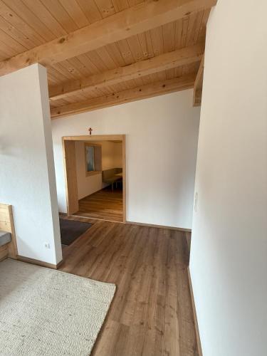 an empty room with white walls and wooden ceilings at Ferienhaus Innergruben in Laimach