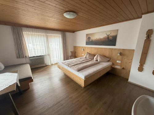 a bedroom with a bed and a wooden ceiling at Ferienhaus Innergruben in Laimach