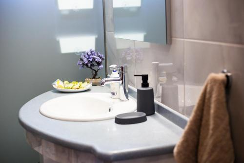 a bathroom sink with a bowl of fruit on it at LiRa in Kremasti