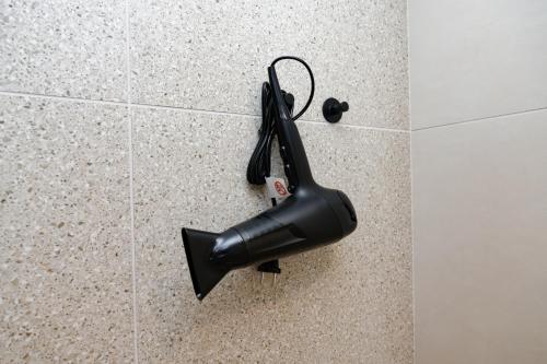 a black umbrella is hanging on a wall at Hotel Arya by Mauro in Sirmione