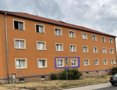 a large orange building with a blue at Apartmán pod Hradem in Most