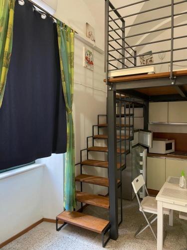 a room with a bunk bed and a spiral staircase at Mare Adriatico-La Barberia Di Italo in Colonnella