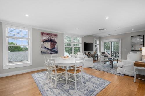 a living room with a white table and chairs at 557 Route 28, Unit 203, Harwich Port Cape Cod - - Perfect Rx in Harwich Port