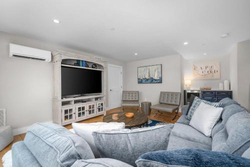 a living room with two couches and a tv at 557 Route 28, Unit 203, Harwich Port Cape Cod - - Perfect Rx in Harwich Port