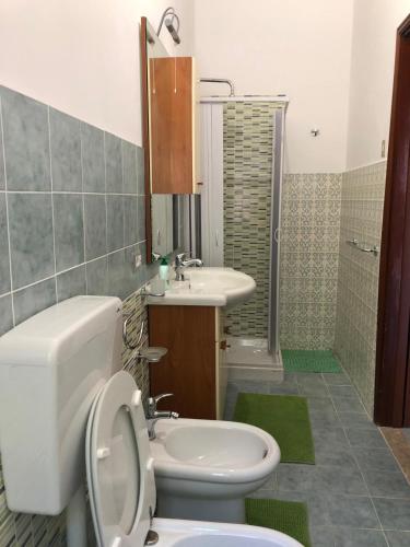a bathroom with a toilet and a sink at Hotel La Quiete in Sinagra