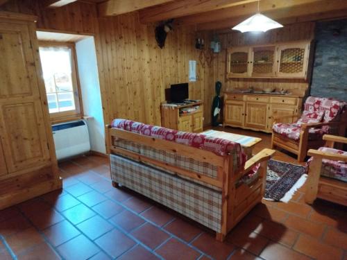 a living room with a couch and a table at La Baita di Savara - nature and silence in Valsavarenche