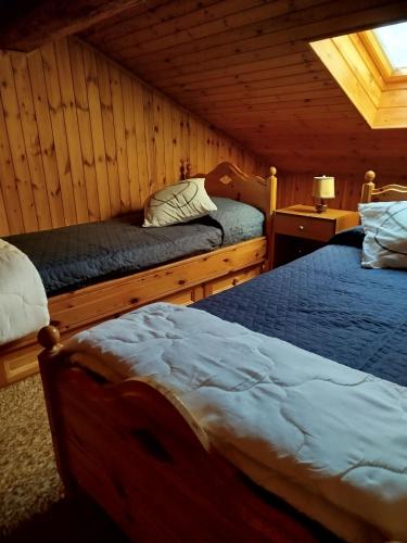 a bedroom with two beds in a cabin at La Baita di Savara - nature and silence in Valsavarenche