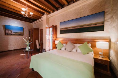 a bedroom with a large bed in a room at Hotel Boutique Casa Catrina in Oaxaca City