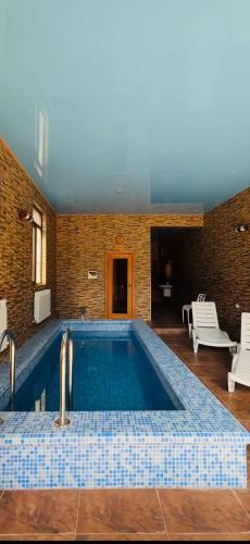 a swimming pool with two faucets in a room at Green villa panorama in Batumi