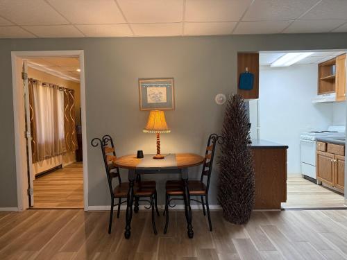 a dining room table with chairs and a lamp on it at Skaneateles Inn on 20 in Auburn