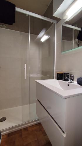 a white bathroom with a shower and a sink at Sullensa # Parking - Proche Centre - Vue Montagne in Thônes