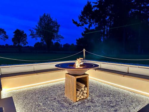 a fountain in the middle of a road at night at Gîte du Soleil dans la Ruelle - Les Hirondelles in Yvré-lʼÉvêque
