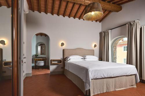 a bedroom with a large bed in a room at Castello Vicchiomaggio in Greve in Chianti