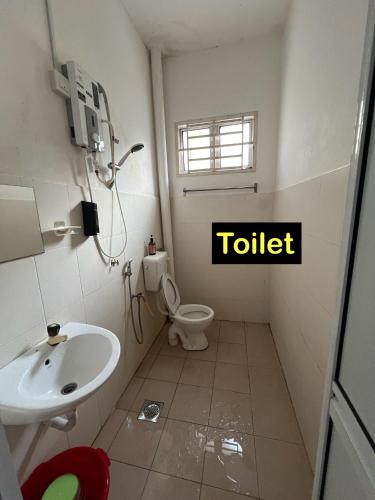 a bathroom with a toilet and a sink at Almai Homestay Batu 4 in Port Dickson