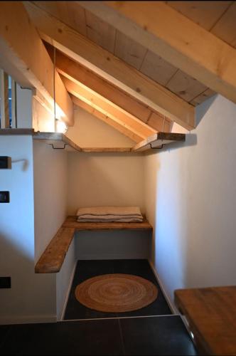 a small room with wooden shelves and a refrigerator at La loge de la Dolarde in Prémanon