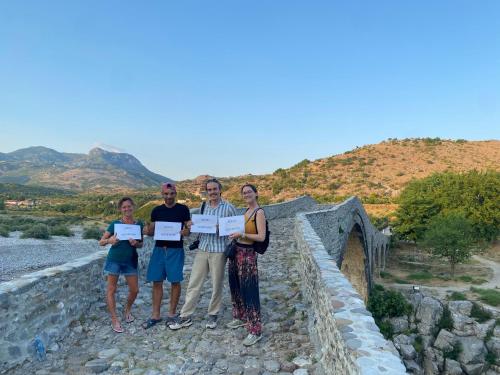 a group of people standing on a bridge at Golden Sleep Hostel in Shkodër