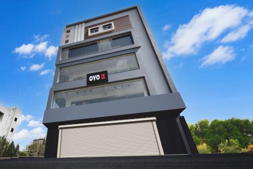 a rendering of a apartment building with a garage at Hotel O SSR Grand in Surūrnagar