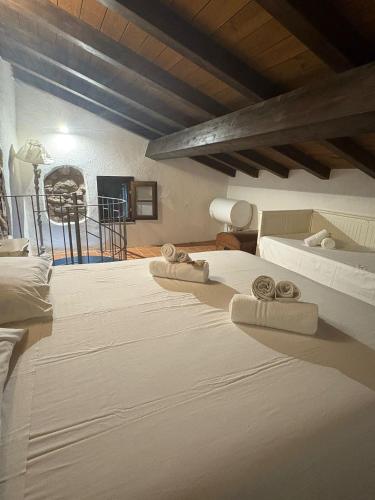 a bedroom with two beds with towels on them at Ca di Rosa in Aulla