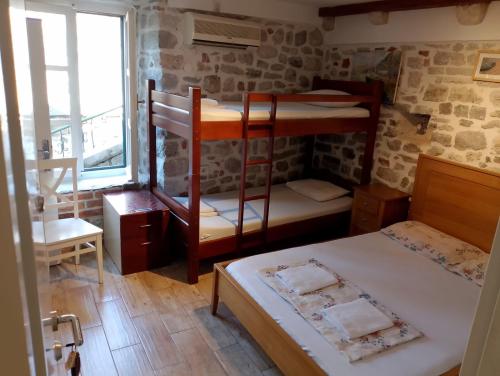 a room with two bunk beds and a window at Apartments Đukić in Kotor