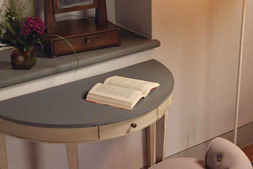an open book on a table with a chair at Castello Vicchiomaggio in Greve in Chianti