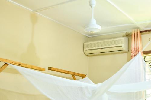 a hammock in a room with a air conditioner at L&J Modern Backpackers Kinondoni in Dar es Salaam