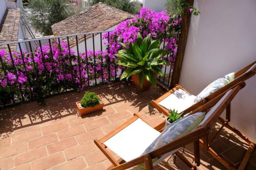 a balcony with purple flowers and a fence at Matriz Home in Portel