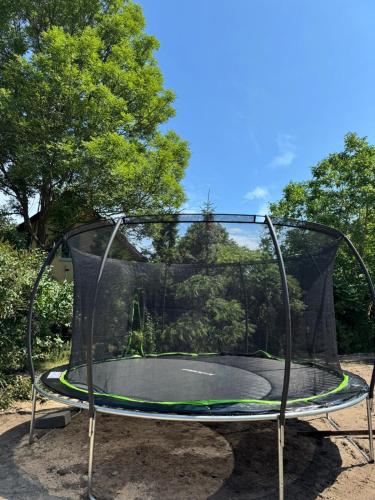 an empty trampoline in a park at Amber Coast domek nr 2 in Jantar