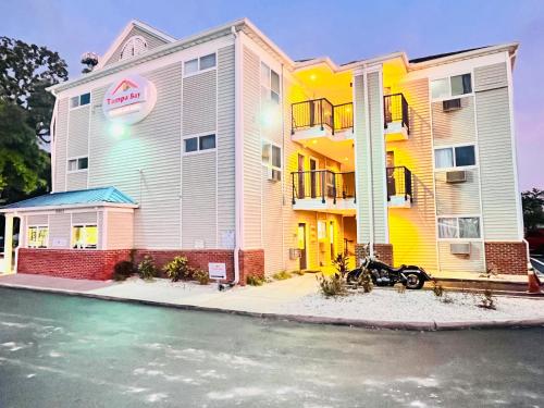 a building with a car parked in front of it at Tampa Bay Extended Stay - Airport in Tampa