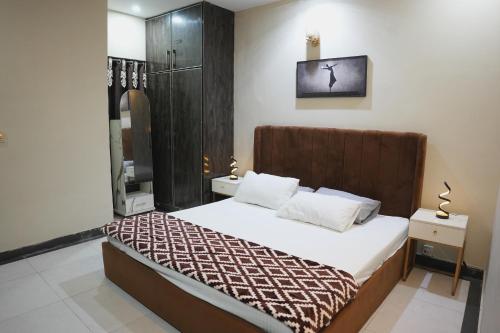 a bedroom with a large bed and a shower at Perfect Place for Family in Lahore in Lahore