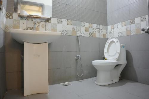 a bathroom with a toilet and a sink at Perfect Place for Family in Lahore in Lahore