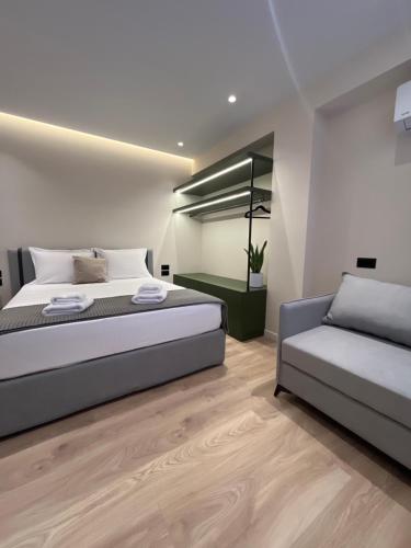 a bedroom with a bed and a couch at Mina Luxury Rooms in Tirana