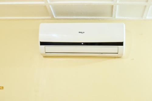 a toaster oven hanging on a wall at L&J Modern Backpackers Kinondoni in Dar es Salaam