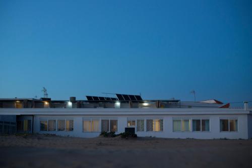 a large white building with lights on top of it at Apartamentos Calypso in Punta Umbría