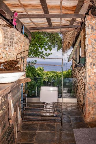 a bathroom with a toilet and a view of the ocean at Casa El Paraiso, Eco Lodge in Santa Bárbara de Samaná