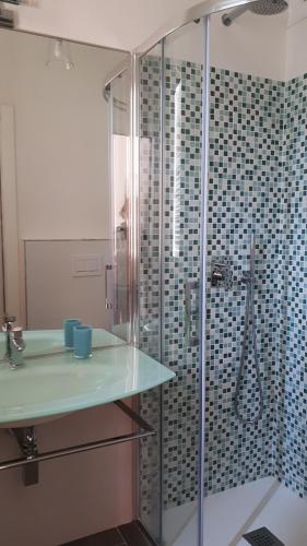 a bathroom with a glass shower and a sink at B&B Tre Confini in Giaveno