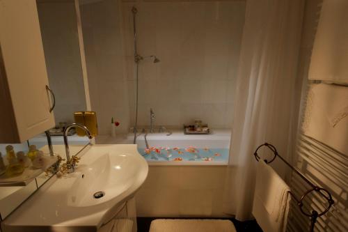 a bathroom with a sink, toilet and bathtub at Antiq Palace - Historic Hotels of Europe in Ljubljana