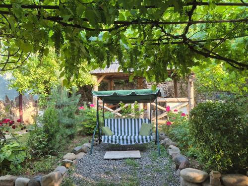 a garden with a gazebo in the yard at Nikala's house in Borjomi