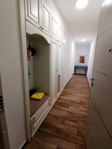 a hallway with white cabinets and wood floors at Your Home Montenegro in Dobra Voda
