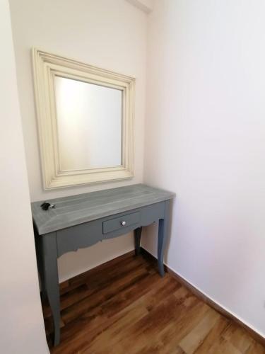 a table with a mirror and a drawer in a room at Your Home Montenegro in Dobra Voda