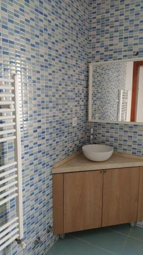 a bathroom with a sink and a mirror at big apartment in the beach in Zambujeira do Mar