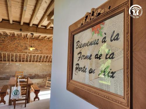 a framed picture of a map on a wall at Chambre d'hôtes au coeur de la Ferme de la Porte en Aix pour 2 in Aix-en-Issart