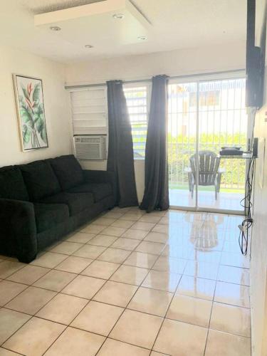 a living room with a couch and a glass table at Beach Apartment C3 Montones in Jobos