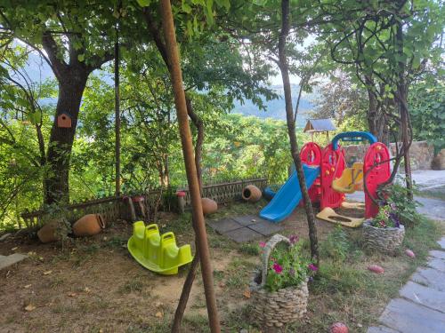 a playground with a slide and a swing set at Nikala's house in Borjomi