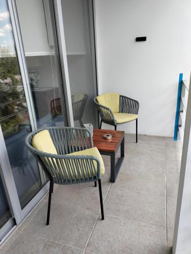 two chairs and a coffee table on a balcony at Casa Laak Fabulous rustic townhouse in Mérida