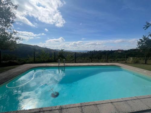 a swimming pool with a view of the mountains at Casa da Costinha in Cinfães