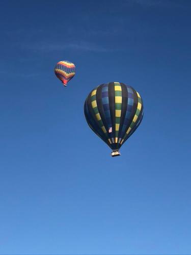 two hot air balloons flying in the sky at Oak Pass Ranch in Paso Robles
