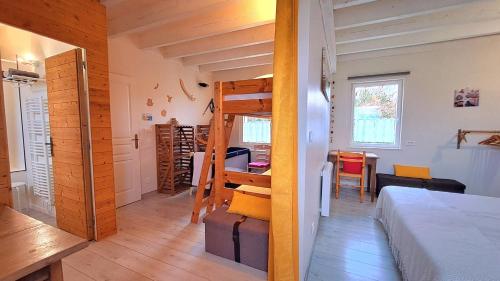 a bedroom with a loft bed and a desk at Gîte 3 chambres Au Gré du Vent, Côte d'Albâtre, Normandie in Malleville-les-Grès
